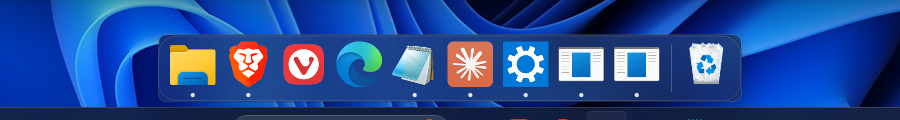 The MackOS dock along the bottom of a Windows 11 desktop, icons magnified under the cursor.